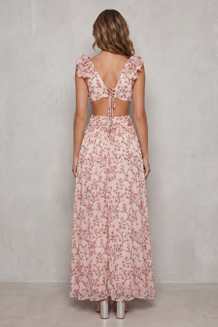 Back of floral ruffle maxi dress in pink floral print with tied open back and ruffled straps