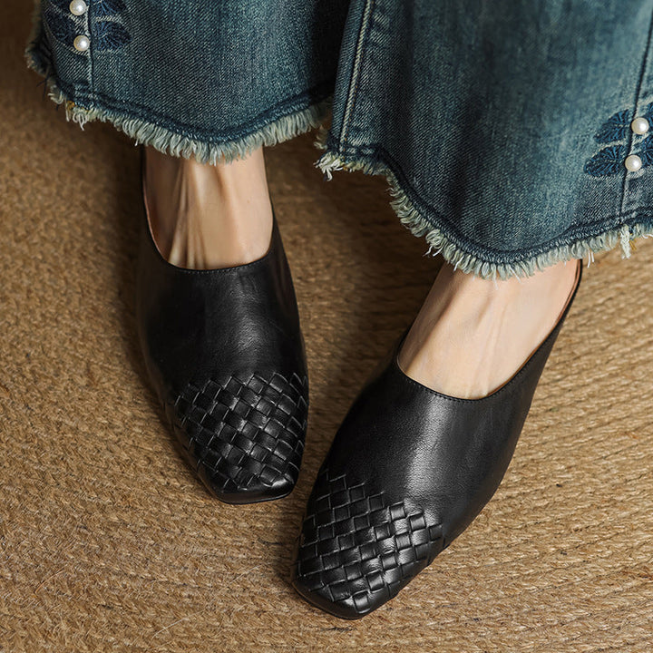 Black woven flat mules pair with crisscross upper and slip-on design