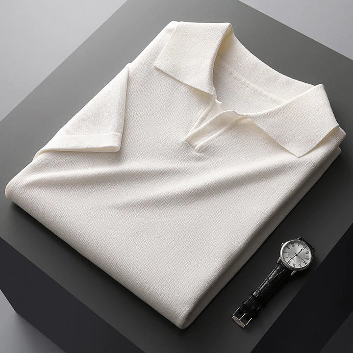 Folded white cotton polo shirt with wide collar and short sleeves