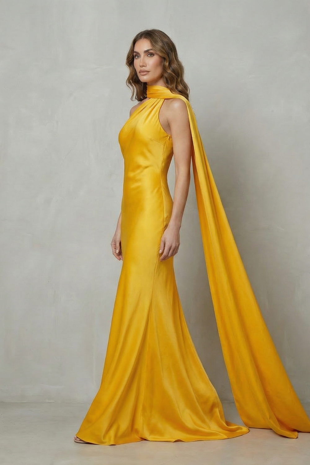 Yellow satin mermaid gown with halter neckline and long trailing side drape