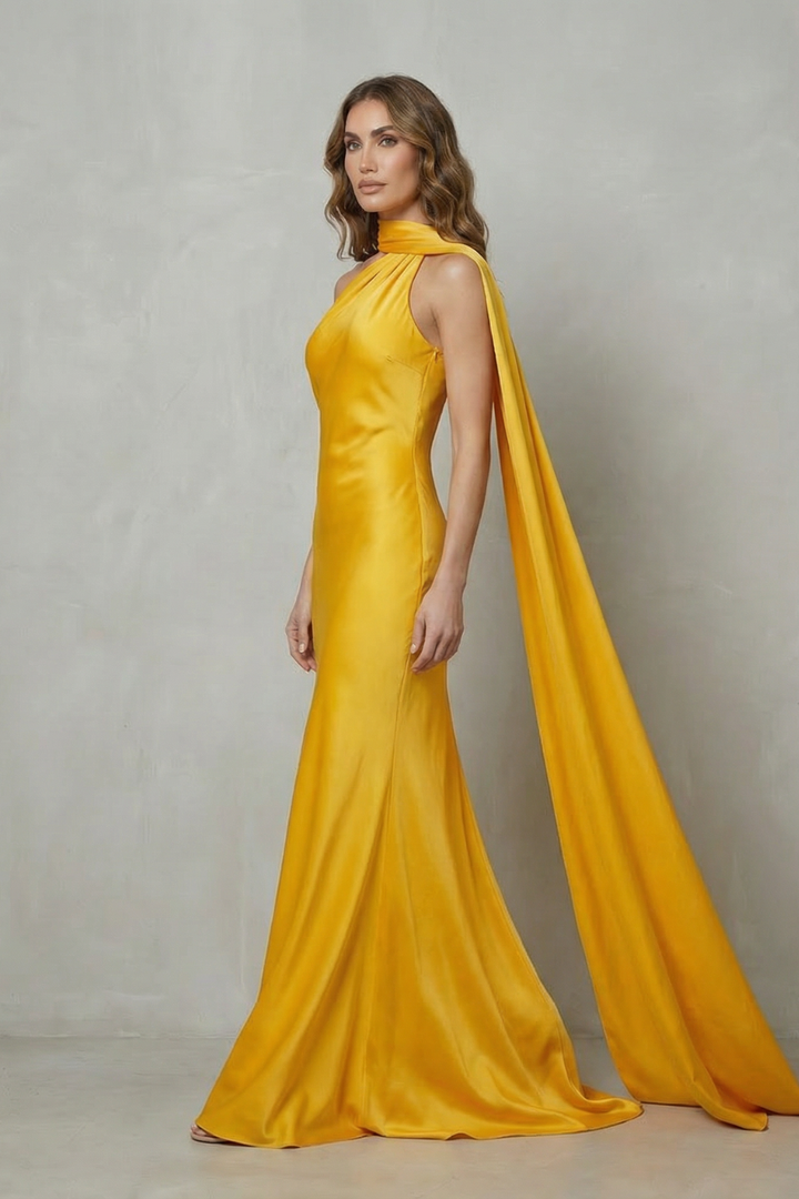 Yellow satin mermaid gown with halter neckline and long trailing side drape