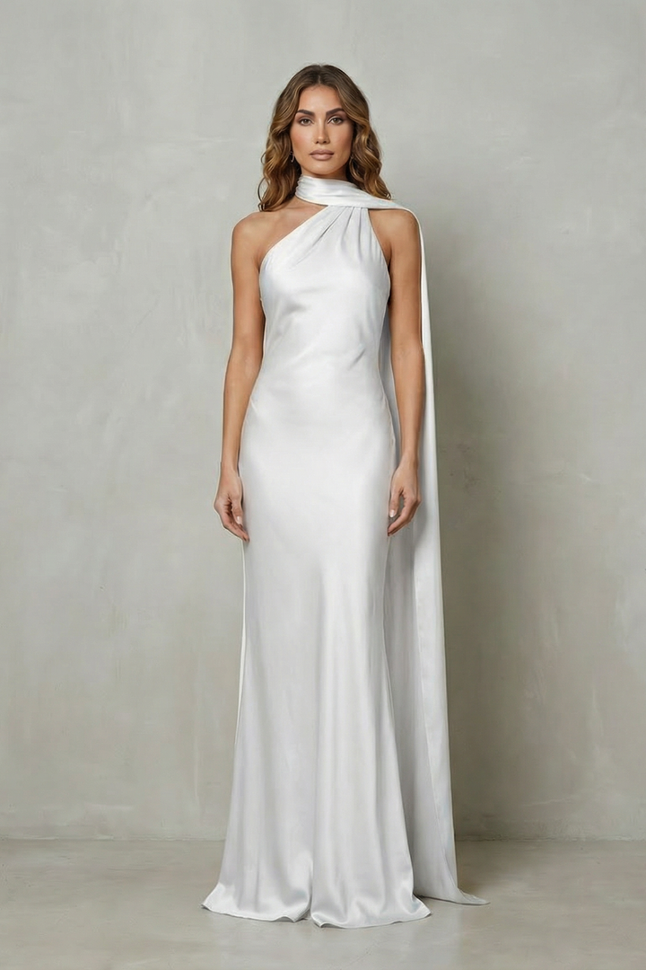 White satin mermaid gown with sleeveless halter neckline and long flowing side drape