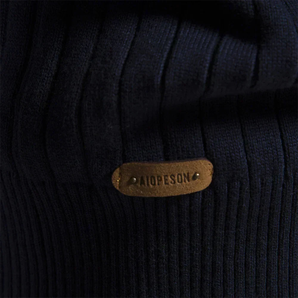 Navy ribbed knit with oval logo patch close-up