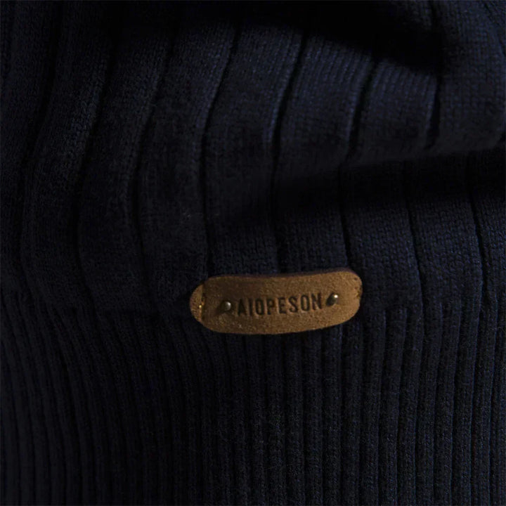 Navy ribbed knit with oval logo patch close-up