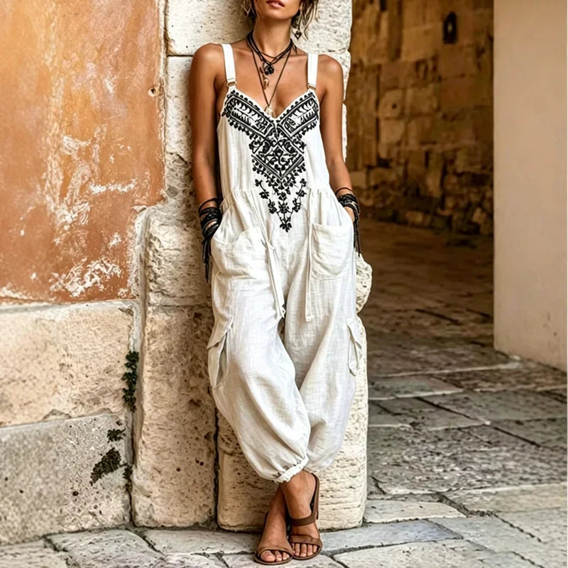 White bohemian jumpsuit with black embroidered trim and relaxed harem-style legs