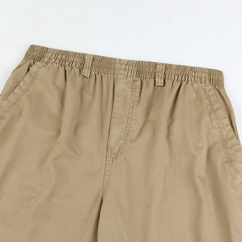 Khaki linen pants waistband close-up with elastic band and front seam details