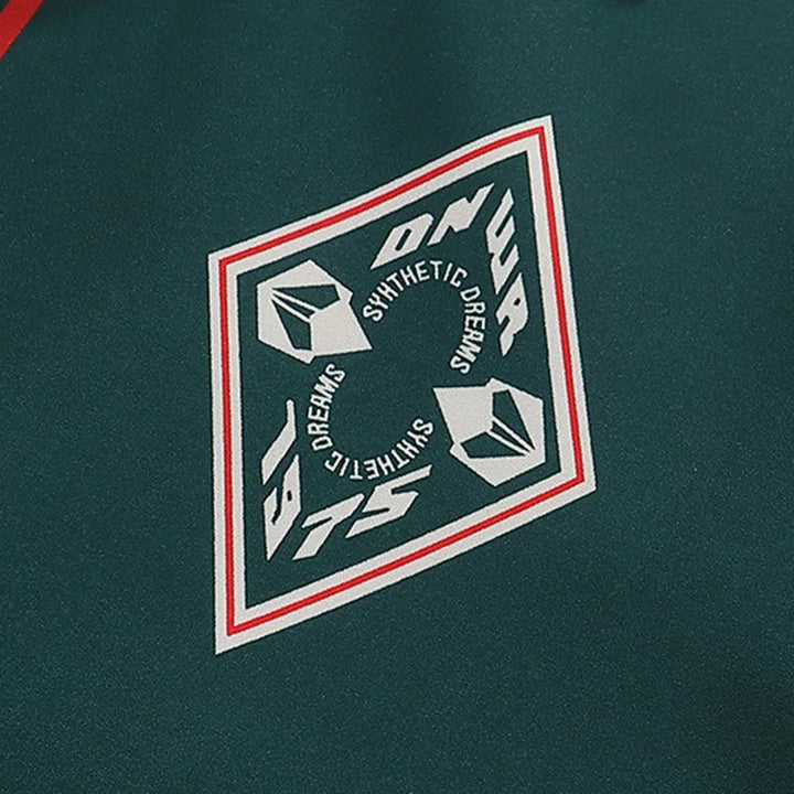 Dark green polo chest patch with geometric crest and athletic-themed icon