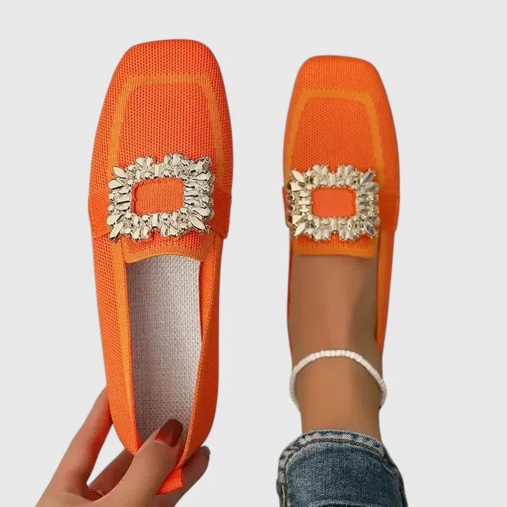 Orange square-toe flats with gold jeweled buckle and subtle textured upper