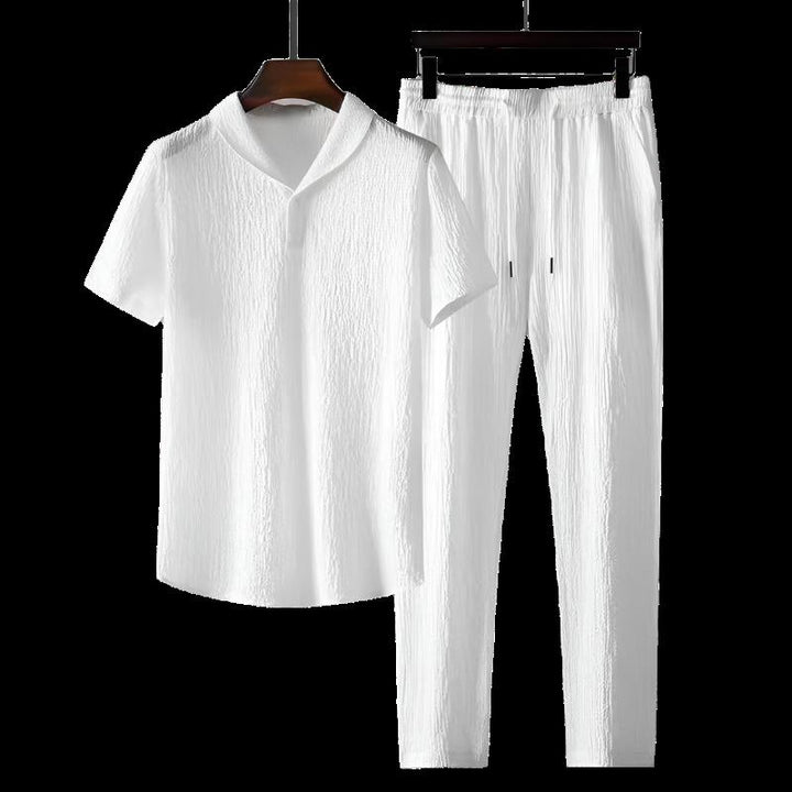 White cotton polo shirt and white cotton pants set with elastic waist.