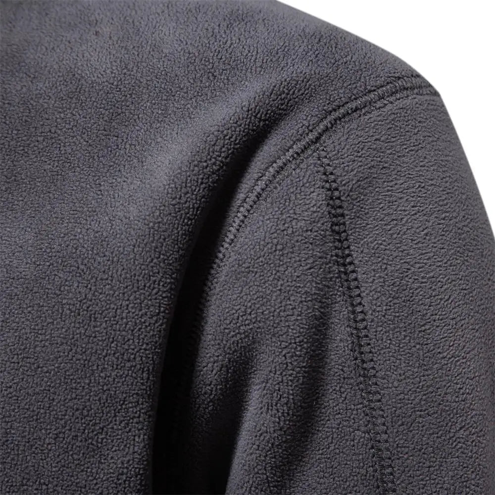 Dark gray fleece windbreaker jacket, shoulder and sleeve seam close-up