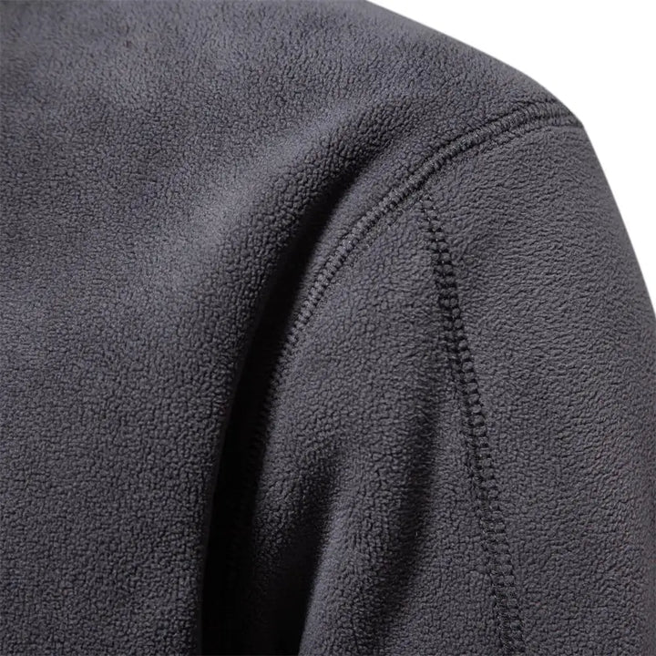 Dark gray fleece windbreaker jacket, shoulder and sleeve seam close-up