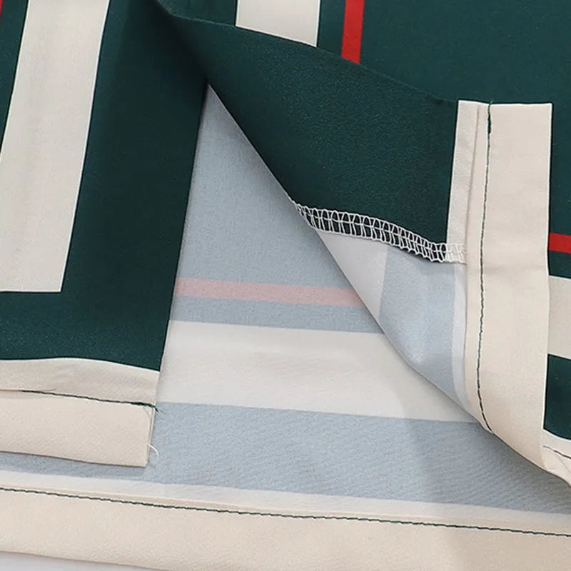 Close-up of polo hem with striped trim, stitched edge, and layered placket details