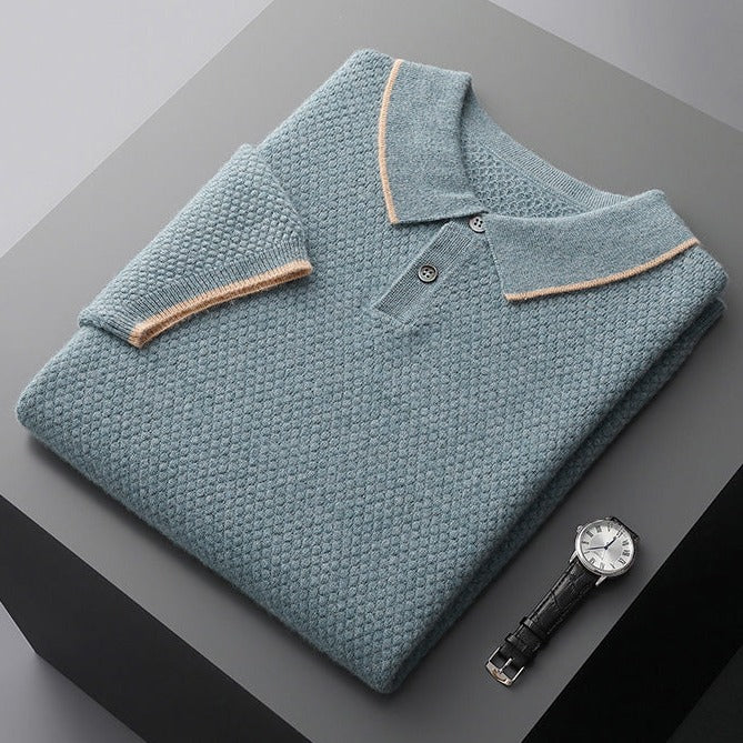 Teal knit polo shirt folded with button placket and tan trim
