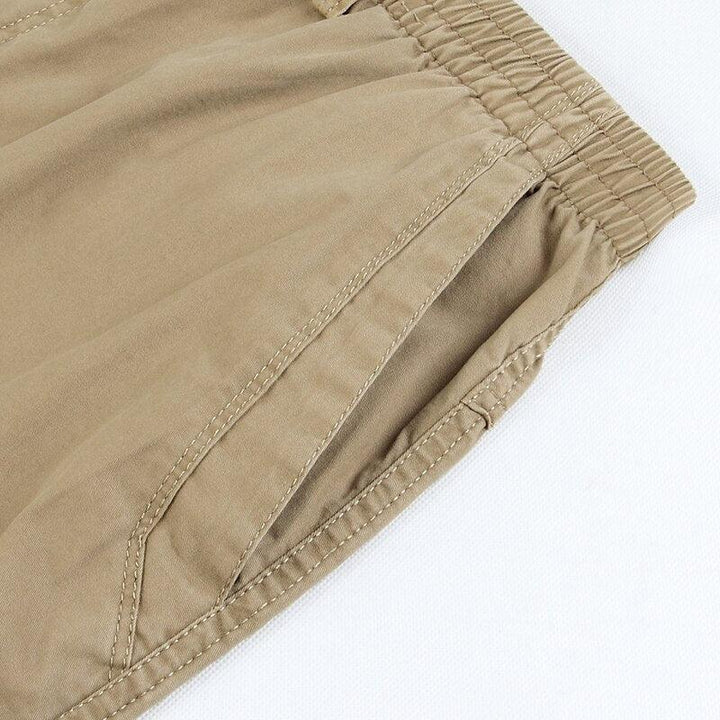 Khaki linen pants close-up of stitched side seam and gathered hem