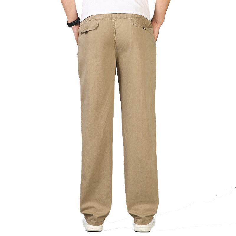 Khaki linen pants from behind with elastic waist and relaxed tapered legs
