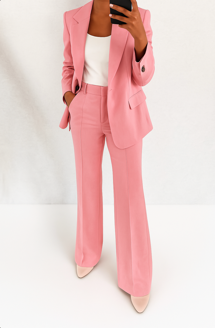 Pink tailored blazer and wide-leg trouser set with single-button closure.