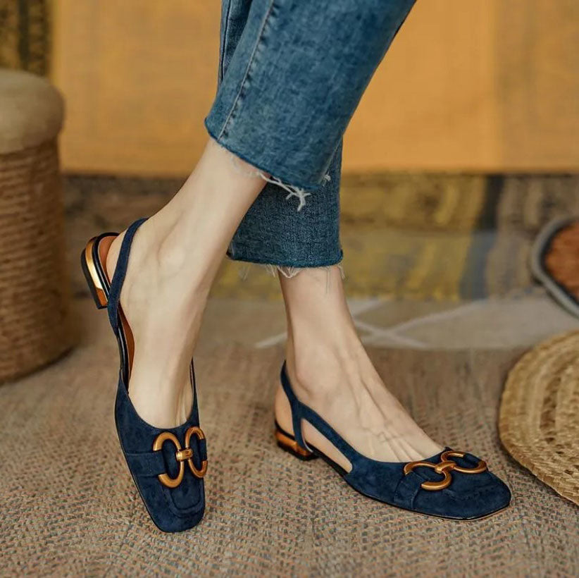 Women’s dark blue slingback flats with buckle strap and low block heel, gold-tone trim