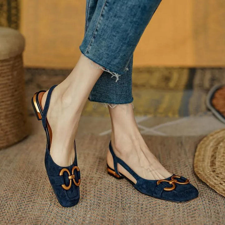 Women’s dark blue slingback flats with buckle strap and low block heel, gold-tone trim
