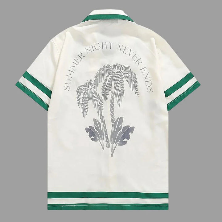 White polo shirt back with palm graphic and curved text, green striped trim at hem and cuffs