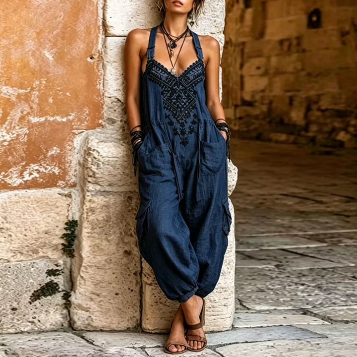 Navy bohemian jumpsuit with black embroidered V neckline and oversized cargo pockets