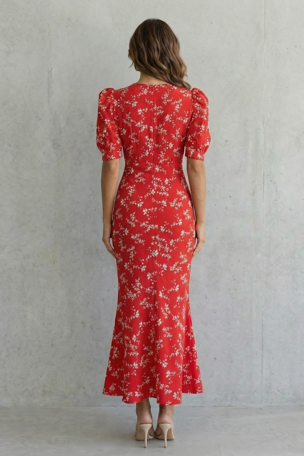 Red floral print maxi dress from back with short puff sleeves, fitted waist, flared hem