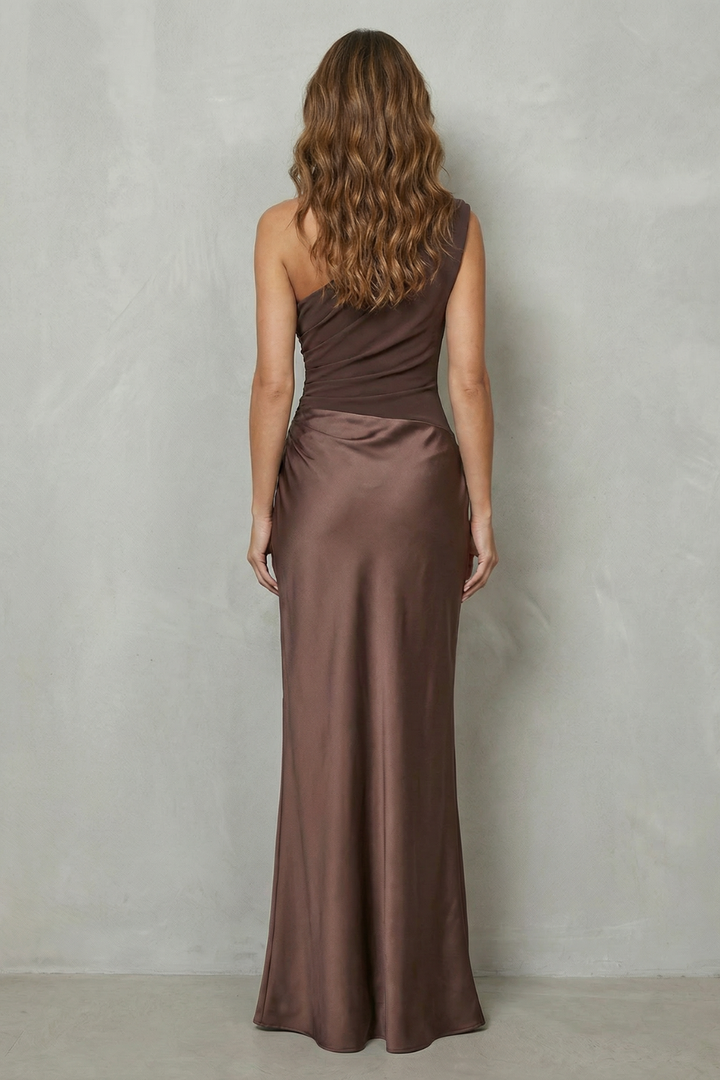 Brown one-shoulder satin evening gown, back view with fitted seam and drape