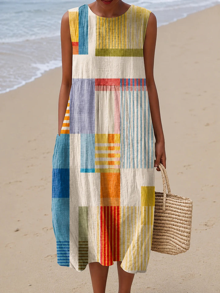 Sleeveless patchwork maxi dress with colorful vertical stripe and block panels.