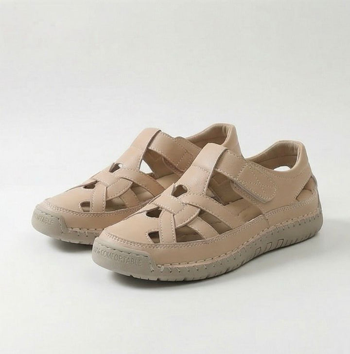 Beige cross-strap comfort flat sandals with wide straps and cushioned tread