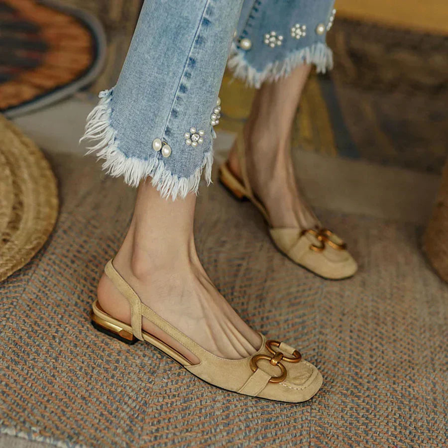 Women’s light beige slingback flats with gold-tone buckle detail and low block heel