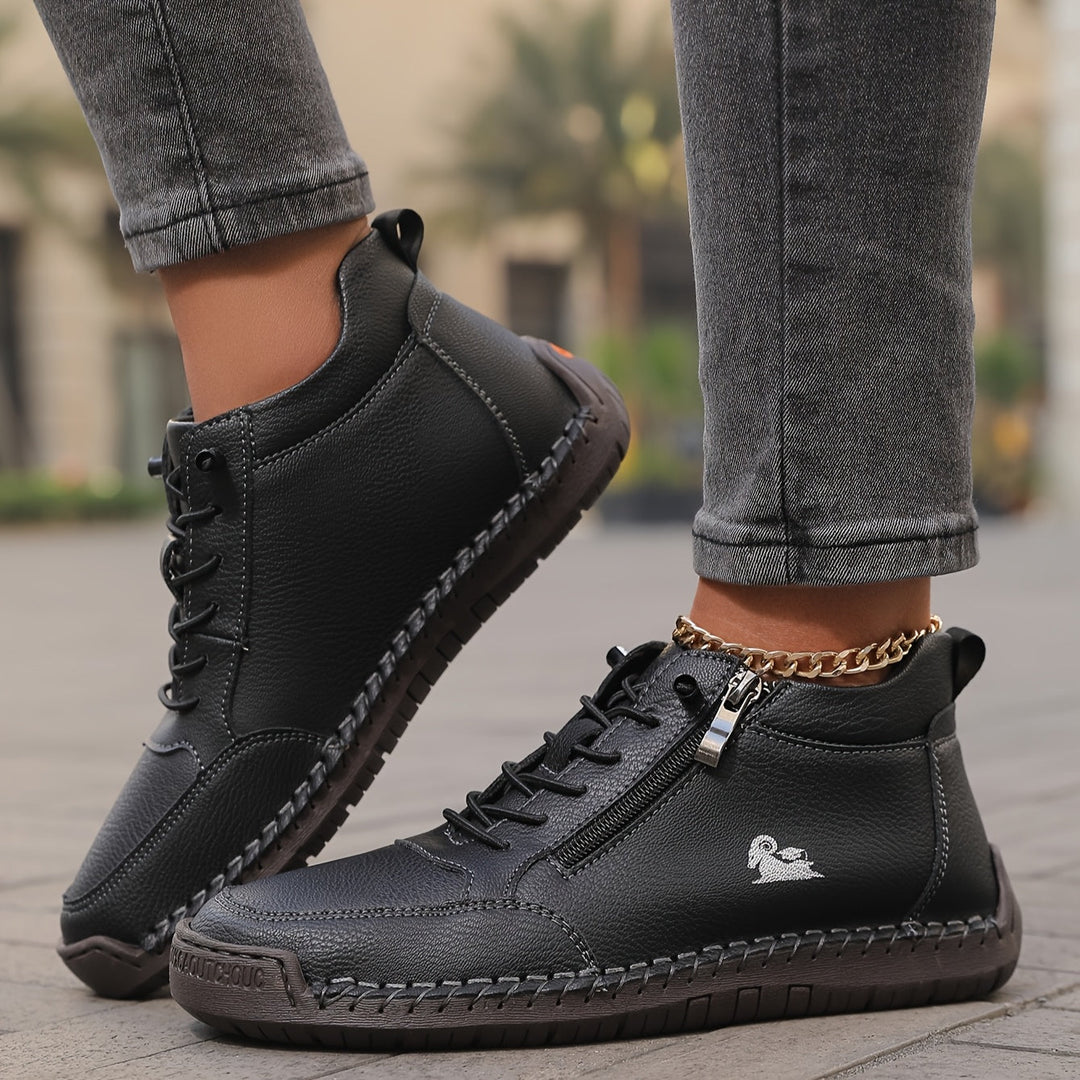 Black side-zip lace-up sneakers with chain detail, stitched toe, and grippy sole