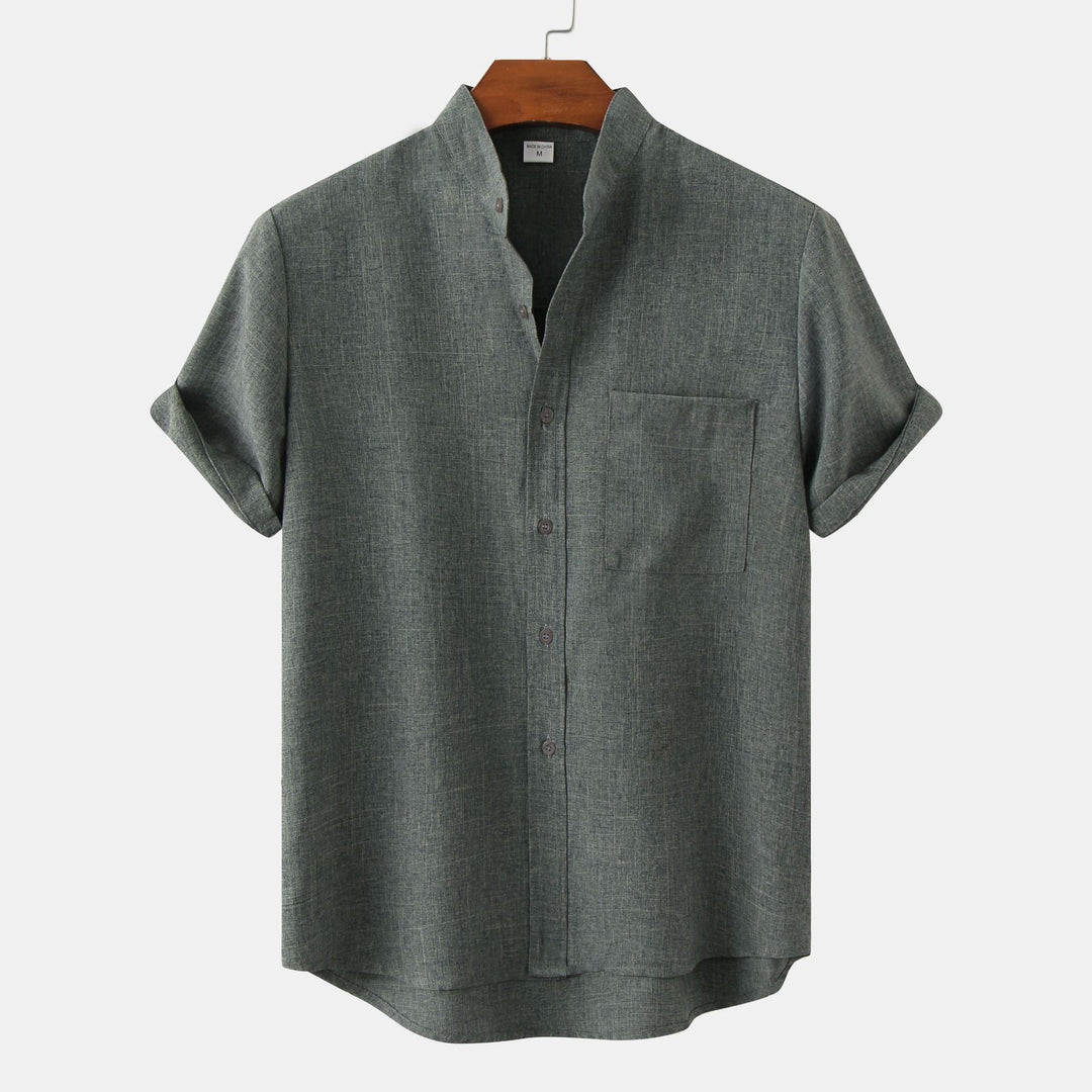 Dark green solid cotton button-up shirt with short sleeves and chest pocket.