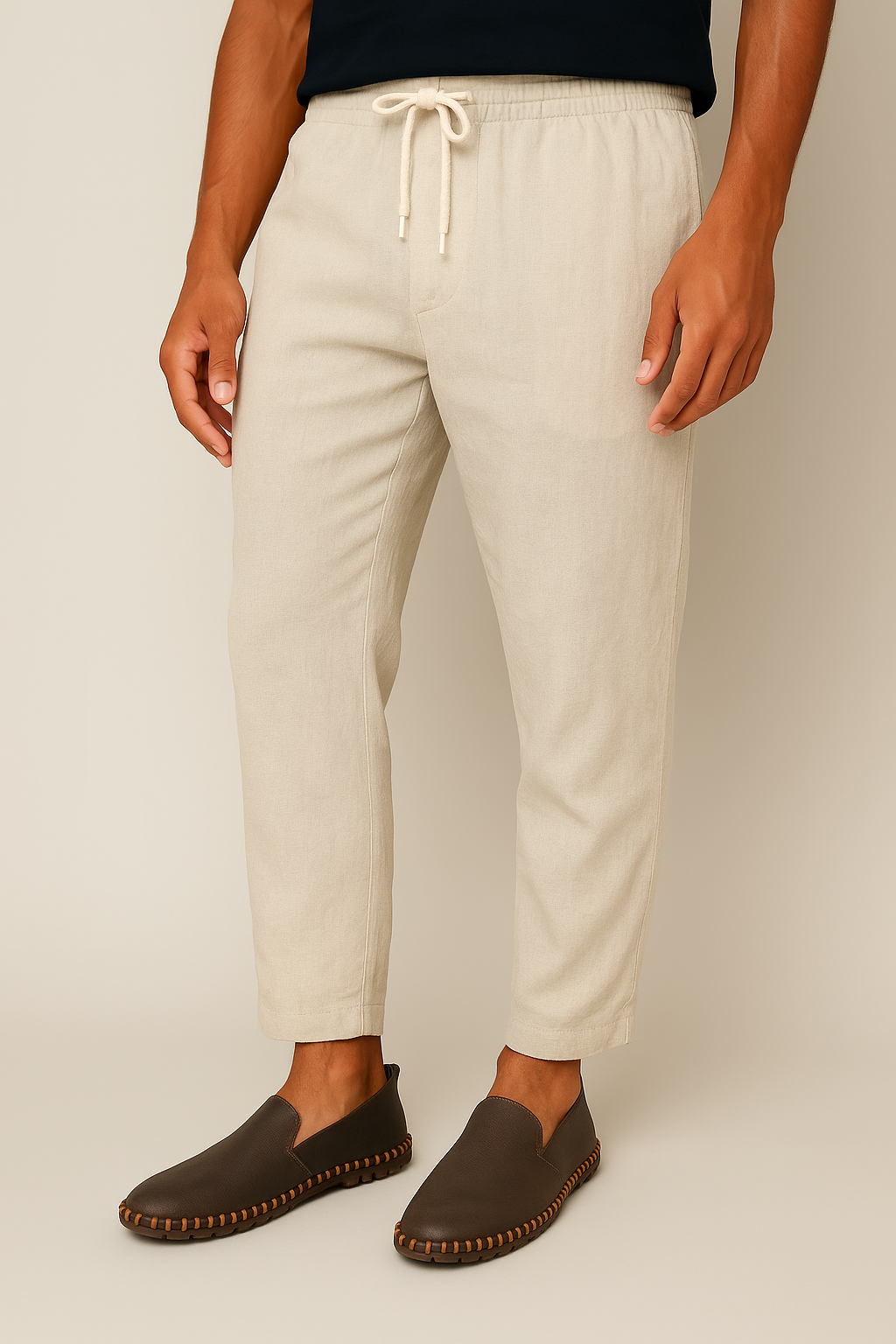 Brown stitch loafers worn with light beige drawstring pants
