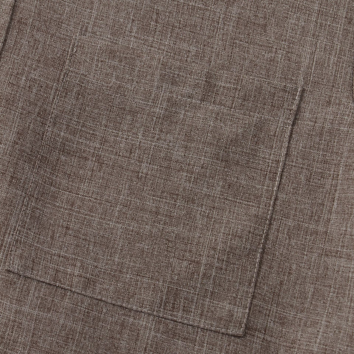 Taupe cotton shirt hem with stitched seam and bottom edge detail.