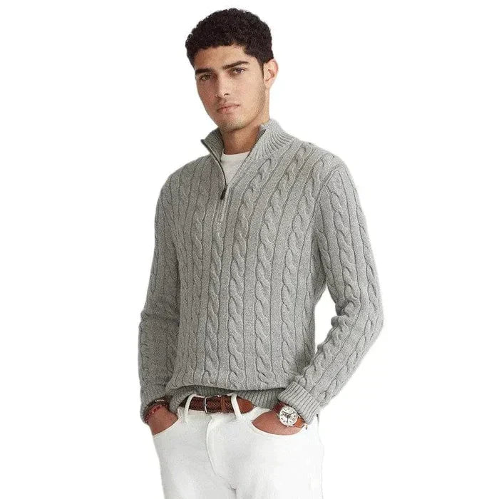 Gray cable-knit half-zip pullover worn by a model, ribbed cuffs and hem visible