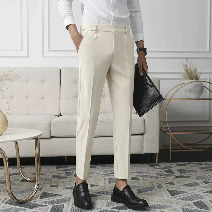 Nude stretch pants on model; straight leg, belt loops, and button front