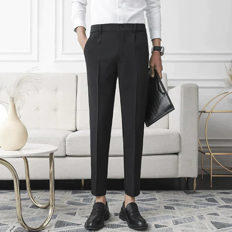 Black stretch pants on model; straight leg, belt loops, and button front
