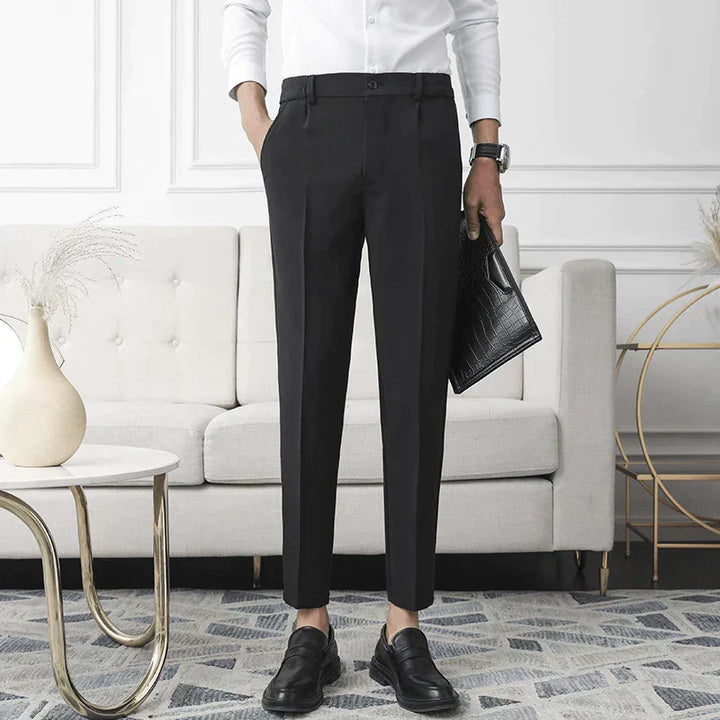 Black stretch pants on model; straight leg, belt loops, and button front