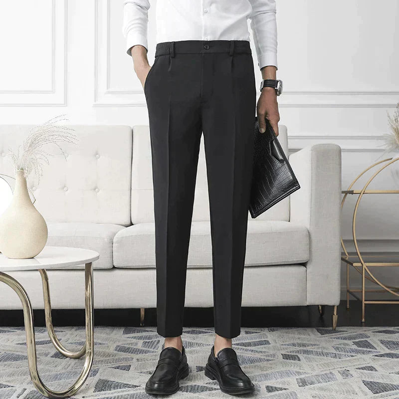 Black stretch dress pants worn with slim fit and ankle-length hem