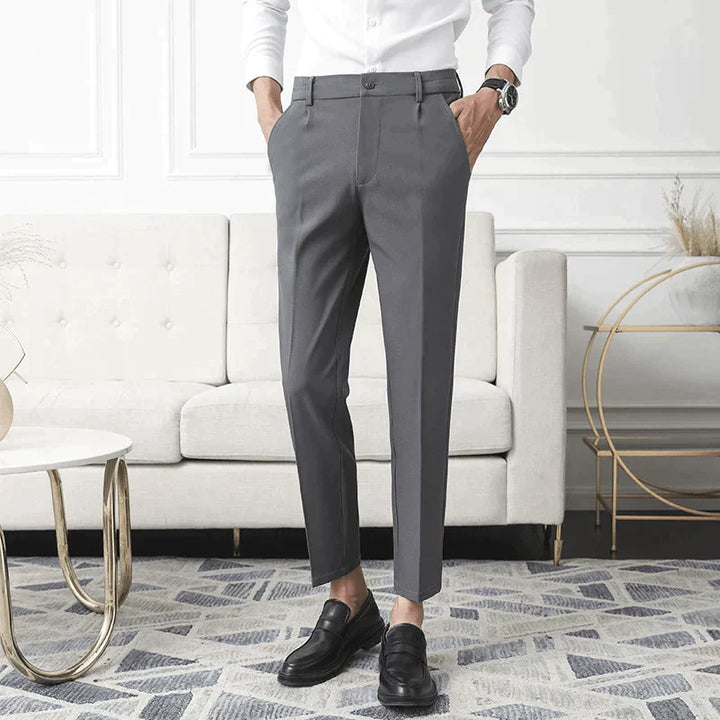 Gray stretch pants worn straight-leg with cuffed ankle hem