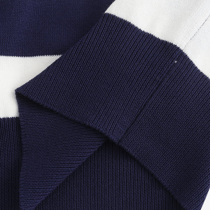 Navy-and-white striped knit polo fabric close-up with textured weave
