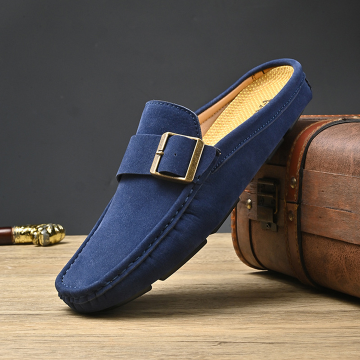 Navy suede loafers with gold buckle strap and moc toe stitching