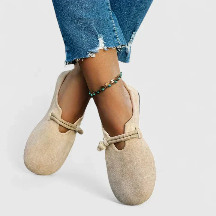 Beige slip-on flats with rope tie detail and rounded toe opening