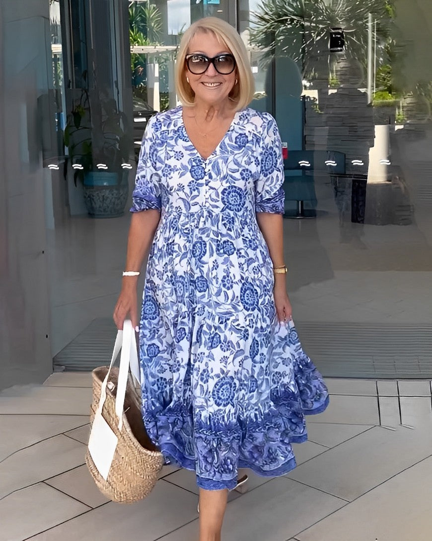 Blue floral V-neck midi dress with short sleeves and tiered ruffle hem