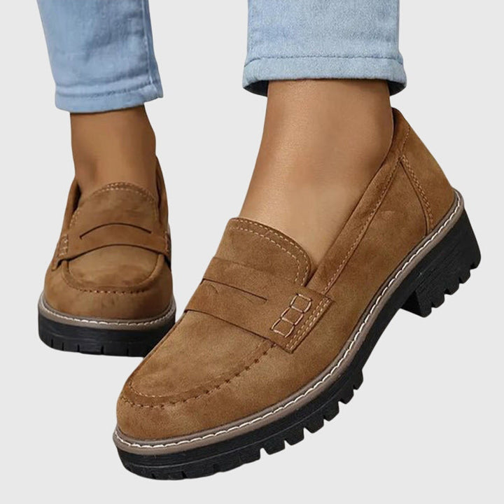 Brown chunky slip-on loafers with strap detail and dark rubber lug sole