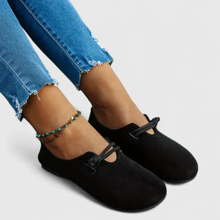 Black slip-on flats with rope band instep detail and rounded toe opening