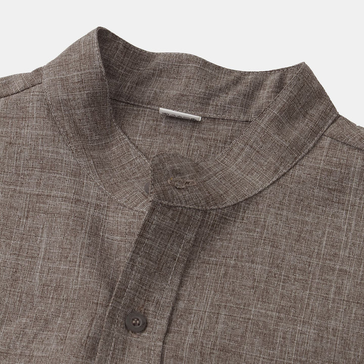 Taupe cotton shirt collar and top button detail on a button-up neckline.