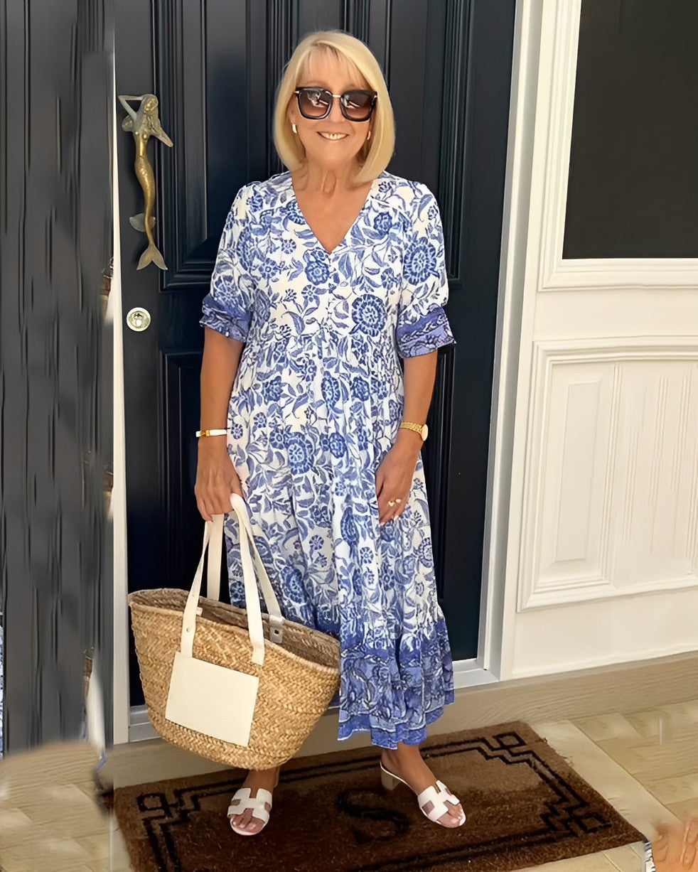 Blue floral V-neck midi dress with short sleeves and tiered ruffle hem, side view