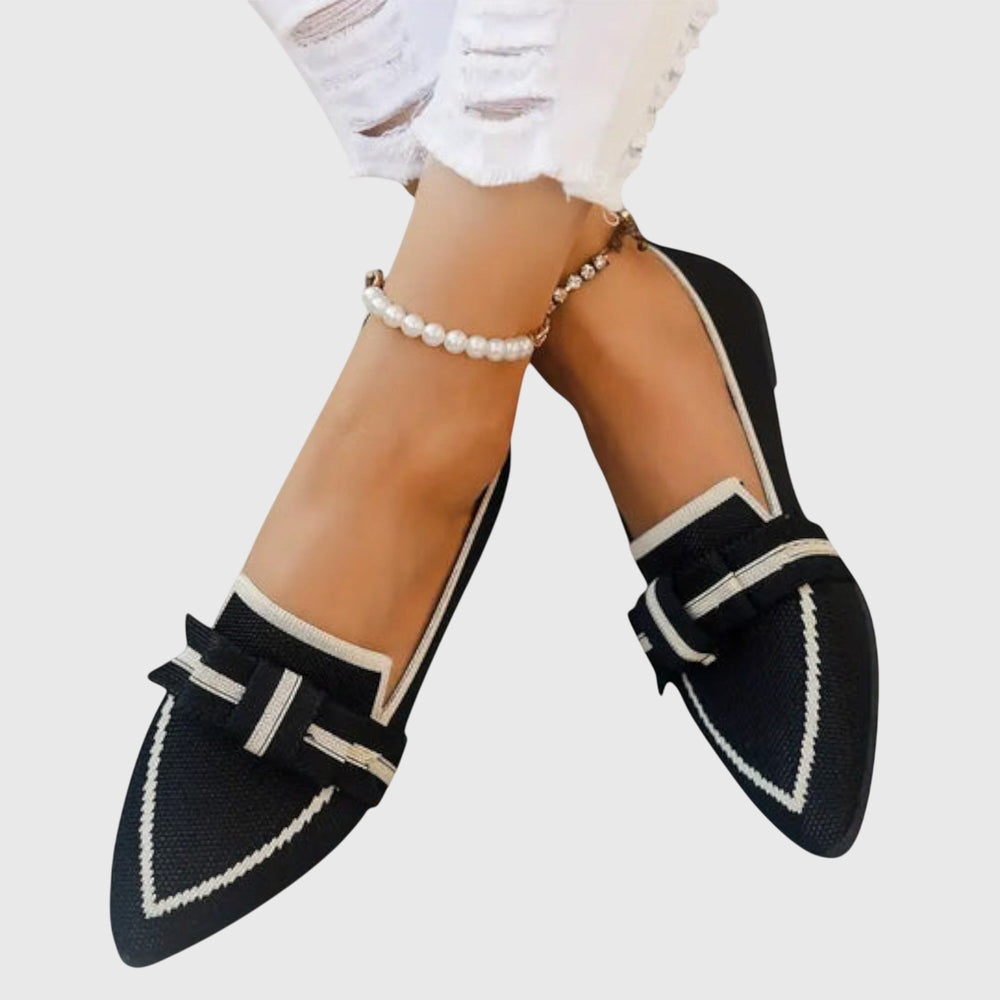 Black pointed toe bow flats with white-edged ribbon and strap bow