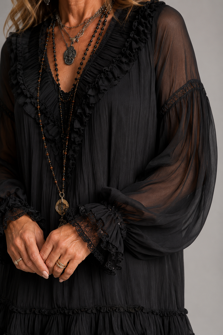 Black V-neck mini dress detail: sheer sleeve, ruffled trim, layered beaded neckline