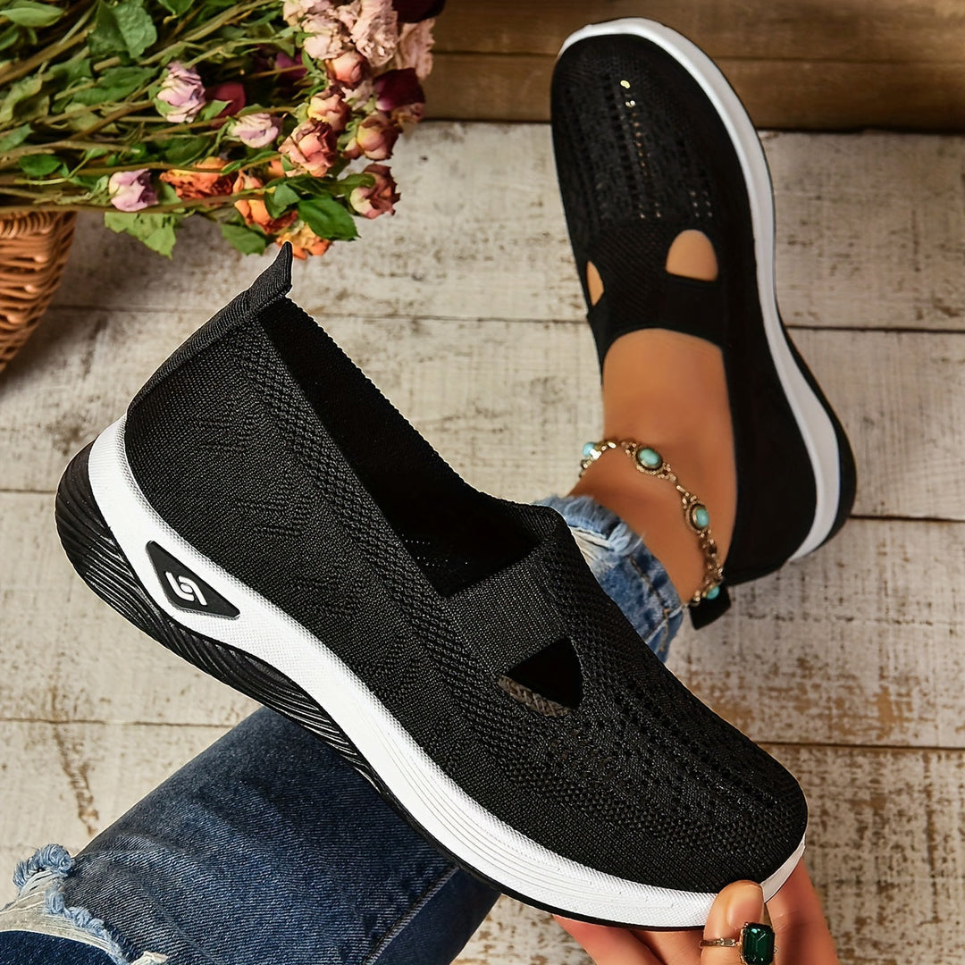 Black knit slip-on sneakers with white sole and toe/side cutout opening